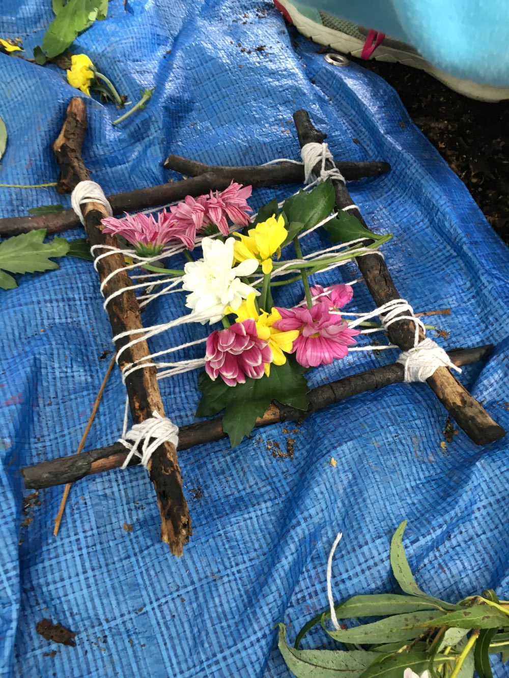 Stick-and-string frame woven with fresh flowers